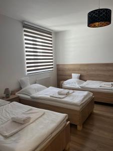 A bed or beds in a room at Penzion Moto