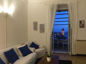 un soggiorno con divano bianco e finestra di Amazing Apartment a Tellaro