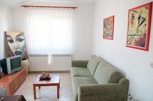 a living room with a couch and a tv at Apartment Anita in Pula