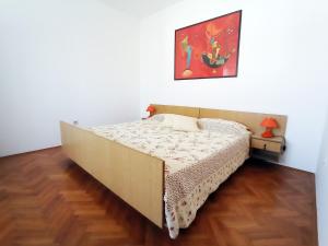 a bed in a room with a painting on the wall at Apartment Anita in Pula