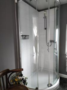 a shower with a glass door in a bathroom at Valley House in Exeter