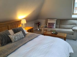 a bedroom with a large bed and a couch at Valley House in Exeter