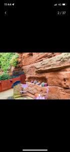 a picture of a rock wall with a table and chairs at Quatford hideaway in Quatford