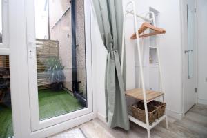 a room with a sliding glass door with a window at Luxury Apartment in Cardiff