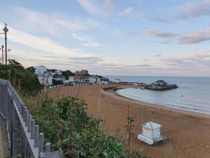 a beach with a white box on the sand at The Seaside Haven W Parking - Mins To Viking Bay in Kent