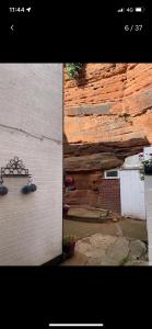 a building with a stone wall with plants on it at Quatford hideaway in Quatford