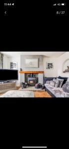 a living room with two couches and a fireplace at Quatford hideaway in Quatford