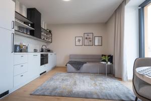 a living room with a couch and a kitchen at GRAY APARTMENT in Banská Bystrica