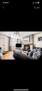 a living room with a couch and a fireplace at Quatford hideaway in Quatford