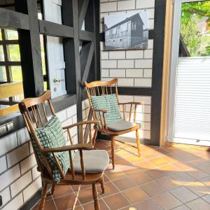 two rocking chairs sitting on a porch at Landhaus Reppel in Bad Laasphe