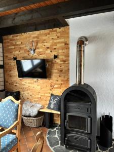 a living room with a stove in a room at Landhaus Reppel in Bad Laasphe