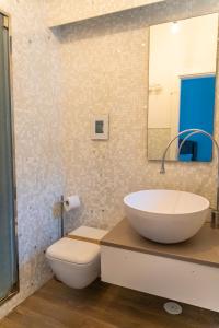 a bathroom with a large white sink and a toilet at Regina Margherita Home in Rome