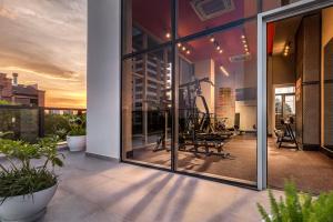 a building with glass doors with a gym inside at ÚNICO - Stay & Residences by AVA in Asunción
