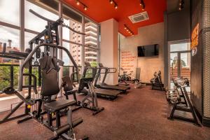 a gym with several tread machines in a room at ÚNICO - Stay & Residences by AVA in Asunción