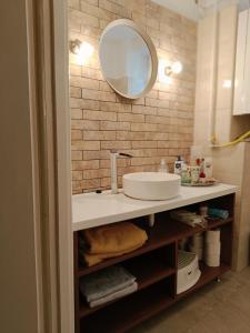 a bathroom with a sink and a mirror at Flat in historic villa with your own private garden, near City Park in Budapest