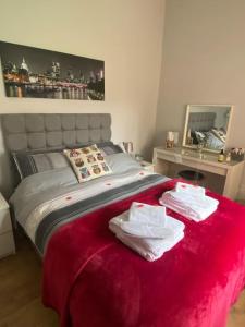 a bedroom with a bed with two towels on it at Owlhoot Annexe in Sudbury