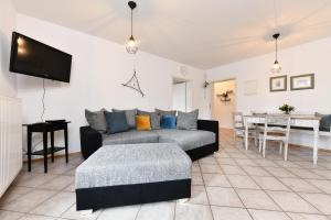 a living room with a couch and a table at Ferienwohnung am Altenlinderstall in Lindlar