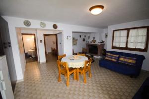 a living room with a table and a blue couch at Elia Apartments Sithonia in Elia