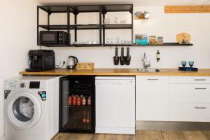 a kitchen with a washing machine and a sink at Pardela Menorca in Es Castell