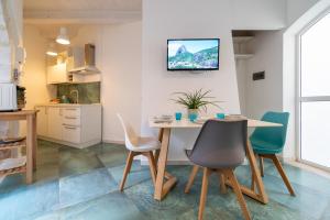 a kitchen and dining room with a table and chairs at Corte Spagnola - Charming Heaven in Ortigia in Syracuse