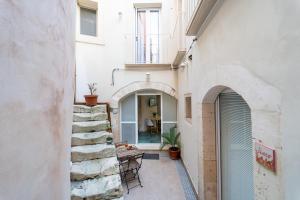 an external view of a building with a stairway at Corte Spagnola - Charming Heaven in Ortigia in Syracuse