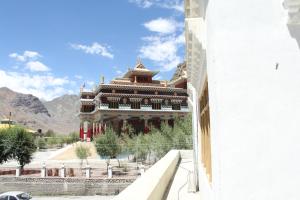 a large building with a mountain in the background at Spiti Valley Hotel in Kaza