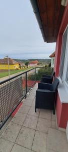 two chairs on a balcony with a view of the ocean at Villa Venezia in Egerszalók