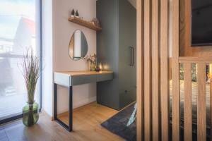 a bathroom with a sink and a mirror at GREEN APARTMENT in Banská Bystrica