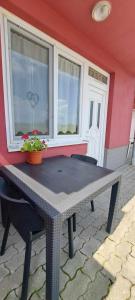 a picnic table in front of a house with a window at Villa Venezia in Egerszalók