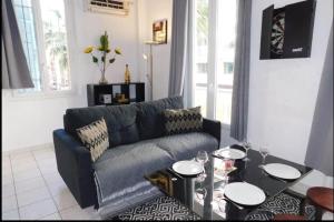 昂蒂布的住宿－Beau T1 bis centre Juan les pins，客厅配有蓝色的沙发和桌子