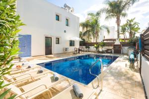 a villa with a swimming pool and a house at Villa Maya - 4bed with Private Heated Pool in Paralimni