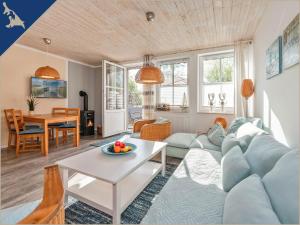 a living room with a blue couch and a table at Ferienwohnung mit Kamin am Achterwasser in Lütow in Lütow