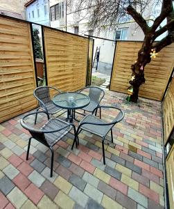 a patio with a table and chairs on a brick patio at Bella Casa - ApartHotel in Dej