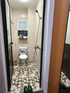 a bathroom with a toilet and a shower at Hanoi Old Quarter Inn in Hanoi