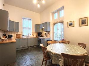 a kitchen with a table and a table and chairs at 3 Bed in Hawkshead Village LLH21 in Hawkshead