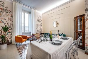 a dining room with a table with wine glasses at THREE APARTMENTS Via Roma in Florence