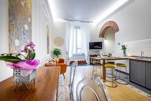 a kitchen and living room with a table and chairs at THREE APARTMENTS Via Roma in Florence