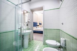 a bathroom with a sink and a toilet and a shower at THREE APARTMENTS Via Roma in Florence