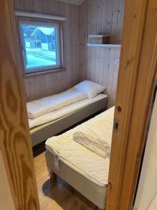 a small room with two beds and a window at Storebælt camping in Korsør