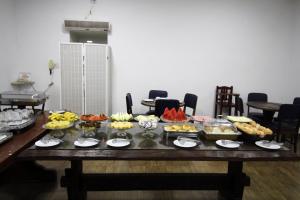 a table with a bunch of food on it at Pousada Água Eterna - Próximo ao Museu de Cera, Hot Beach e Thermas dos Laranjais - By UP Hotel in Olímpia