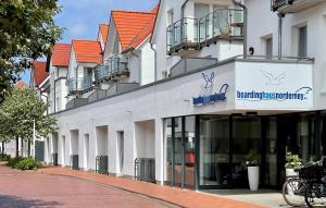 a building with a sign on the side of it at Ney3 in Norderney