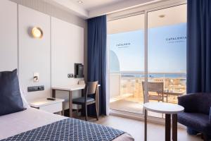 a hotel room with a bed and a view of the ocean at Catalonia Majórica in Palma de Mallorca