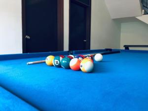 a group of billiard balls on a pool table at Relaxed Family Home by StayCo - Quiet Neighbourhood in Ayer Itam