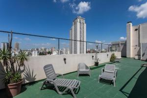 a patio with two chairs and chairs on a roof at HOUSE LORCA in Buenos Aires