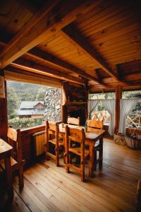 a wooden dining room with a table and chairs at Casa del Lago Villa La Angostura in Villa La Angostura