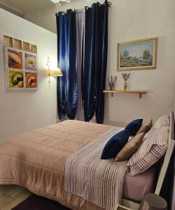 a bedroom with a bed with blue pillows on it at B&B Villa Emilia Milano in Milan