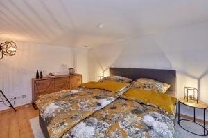 a bedroom with a large bed and a table at Penthouse Palais Mosel in Traben-Trarbach