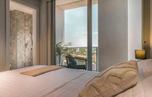 เตียงในห้องที่ ÚNICO - Stay & Residences by AVA