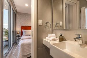 เตียงในห้องที่ ÚNICO - Stay & Residences by AVA