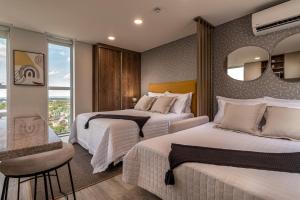 เตียงในห้องที่ ÚNICO - Stay & Residences by AVA